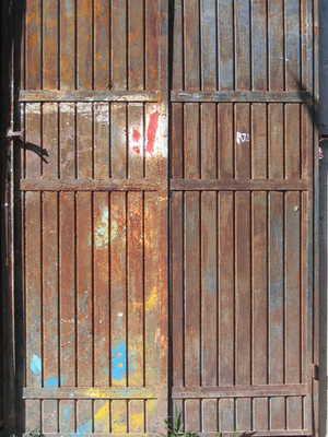 A steel door with splashes of orange and blue